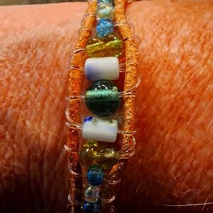 Bohemian leather and beaded bracelet with botton clasp